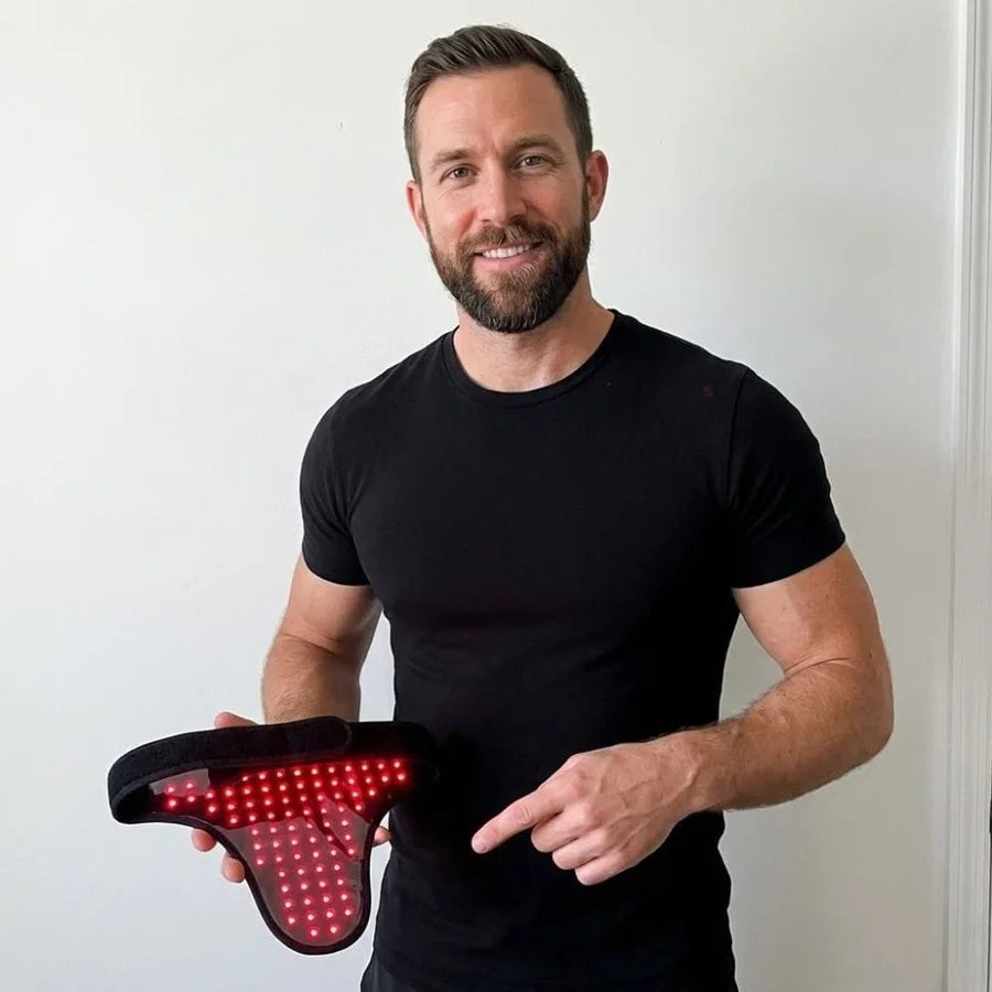 Man holding the illuminated UroGlow wearable